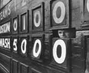 The boy running the scoreboard at Griffith Stadium, peeping out through a slot during a Boston/Washington game. (Washington D.C./July 1956/Hank Walker, photographer) from boy running alamy