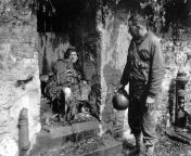 The dead German soldier in this June 1944 photo was one of the &#34;last stand&#34; defenders of German-held Cherbourg. Captain Earl Topley, right, who led one of the first American units into the city on June 27, said the German had killed three of his m from victorua june