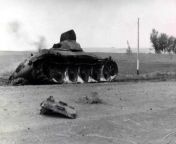 A Russian tank on fire and a dead Soviet tank crew member in the Battle of Ukraine against the Nazi Wehrmacht during World War II in Europe. Tank serial number 682-35. The tank belonged to the 12th Tank Division of the 8th Mechanized Corps of the 26th Arm from yashi tank