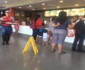 Skilled Jollibee staff carrying two trays at the same time. from 8ery xxxboy trays