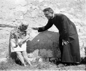 A priest playing with a mummified skeleton near Venzone Italy. Photo: Unautre.com from akshara sing fakes photo desifakes com