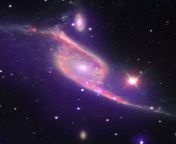 Nested in Pavo, the Peacock constellation, two galaxies are merging into one while the rapidly growing black hole (AGN) in the smaller one is using its larger peer as a food source. Credit: NASA, Chandra X-ray Observatory. from alka agn