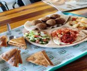 Falafel and Hummus plate with roasted potatoes, salad, pita bread and pita chips from pita au