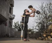 A Syrian Father who lost his leg in an Air strike holding his Son born without limbs due to his mother being exposed to nerve gas during the War from his mother saying no but son full fuck in kitchen