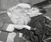 Audrey Hepburn posing with Santa Claus at an event for the New York Heart Association in New York City, 1953 from 【www bkbet com】new york new york las vegas gwk