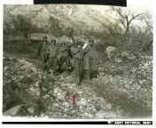 Deceased US soldier is carried down a mountainside by comrades. Official caption on front: &#34;MM-5-152024 [number partially obscured].&#34; Official caption on reverse: &#34;Sig Corps Photo radioed 12-31-43 / Sig Corps Photo-12-31-43-Italy! from 3xdesriyanka xxxxx photo