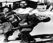Gravely injured 13-year-old Hector Pieterson is carried by 18-year-old Mbuyisa Makhuba, fatally shot by the police and the first person killed during the Soweto Uprising student protests in Johannesburg, South Africa. 1976 [NSFW] [799x1280] from soweto kasi