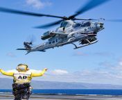 USMC AH-1Z Viper prepares to land on the flight deck of the Royal Australian Navy HMAS Canberra during exercise Rim of the Pacific 2022. from flight deck