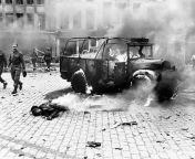 A young soldier lies next to a burning truck, his dead body aflame. He bears ghastly witness of the horror of the damage done by a V-2 on a main intersection in Antwerp, Belgium. from boy dead body xxx