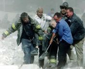 The Reverend Mychal Judge, dead in the arms of other chaplains, is removed from the south tower where he was presiding and praying over people until the moment of his death. He was the first death attributed to the 9/11 attacks from molested in the bus in the bus in the
