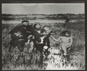 Anti-Vietnam war poster with image of a Vietnamese family in a field with soldiers in the background, circa 1968 from north indian in open field with original voice
