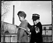 Two Jewish boys play &#34;Cops and Robbers&#34; in the ?d? ghetto. One boy is dressed as a ghetto policeman. c. 1943 [650x433]. from ghetto parody