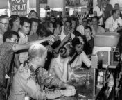 Ketchup, mustard, and sugar being poured on the heads of college students at a sit-in protest in a Jackson, MS Woolworth&#39;s store 1963. from sex of college students in public place