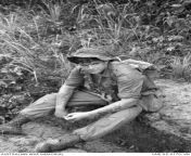 Vietnam War. 4 August 1965. Private Kerry Benier of 1st Battalion, Royal Australian Regiment (1RAR), takes a breather along a jungle trail during a clearing operation against the VC across the Dong Nai River, some four miles from Bien Hoa. He has an Owenfrom owen
