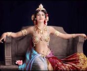 Mata Hari, an international woman of intrigue, an entertainer/dancer, courtesan, and alleged double agent spy in WW1, is posed in her late twenties in Paris. 1906. colorized. from jai mata de