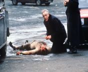 Catholic Priest giving last rites to a British soldier who was stripped naked and shot by the IRA. Belfast, 1988. [2560 × 1707] from naked catholic teen with tattoos doing you must be the girl tiktok trend