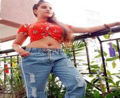 Jolly Bhatia navel in red top and blue jeans from jolly bhatia