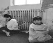 Two autistic kids tied to the radiator of a mental asylum in 1982. Yes, 1982. from athisaya piravigal 1982